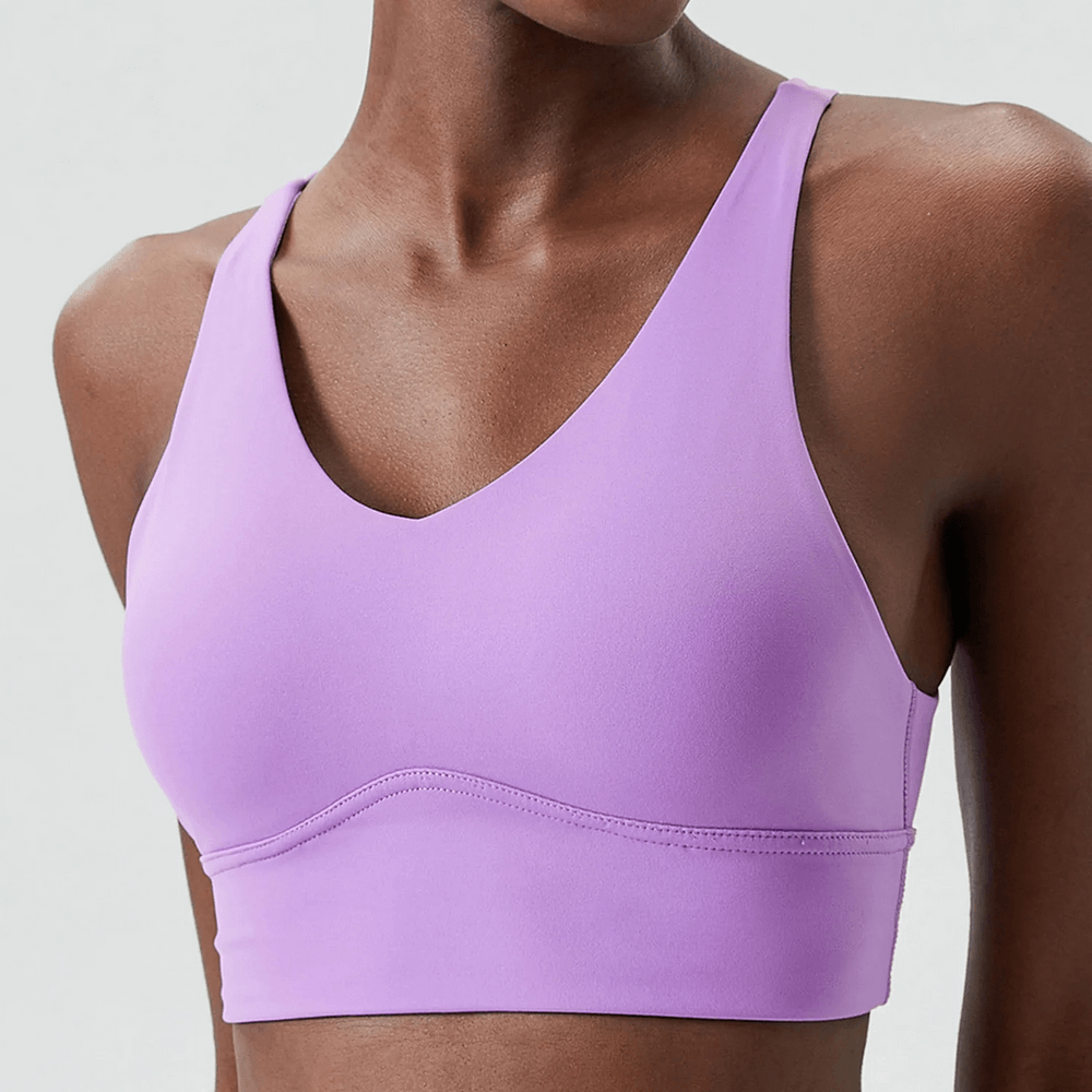 Lavender sports bra with scoop neckline and racerback, offering sleek support for active lifestyles.